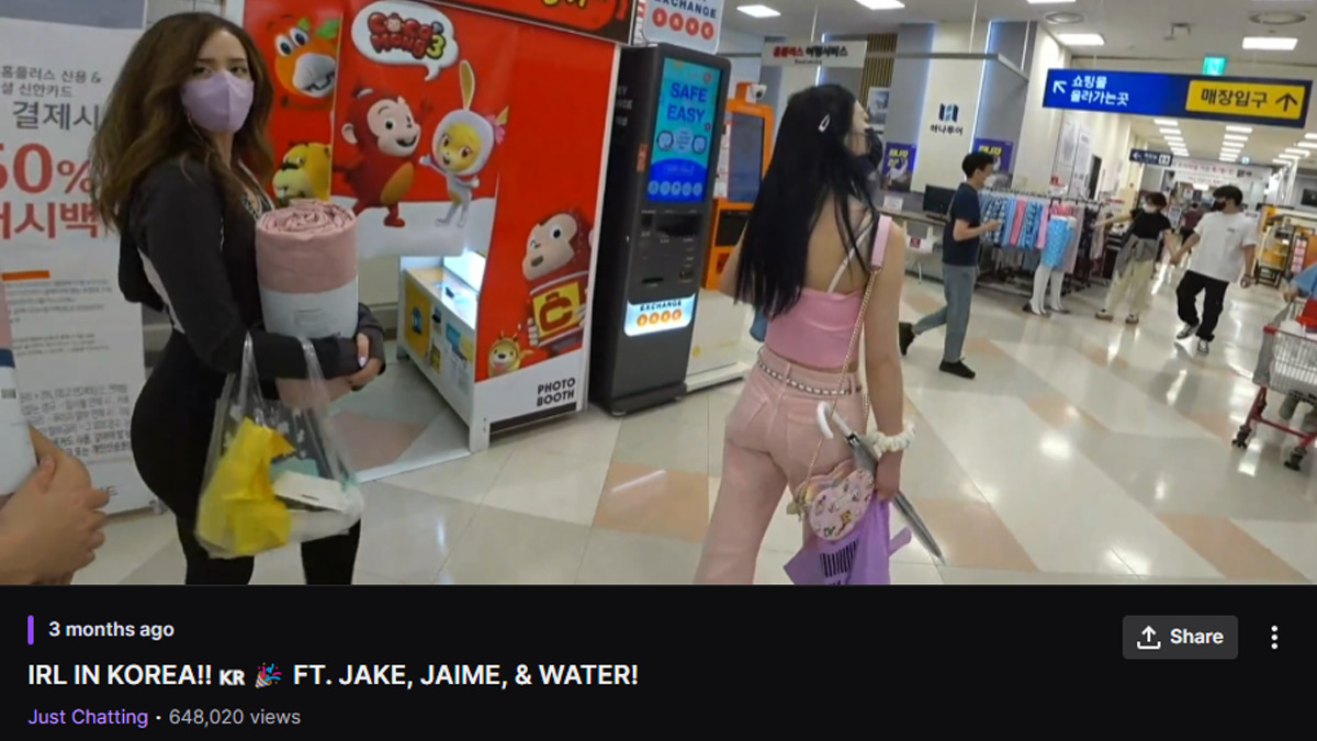 Pokimane walks through a Korean store holding a blanket. The screenshot is from an "in real life" stream that Pokimane did during her trip to Korea. Image via Esports.gg.